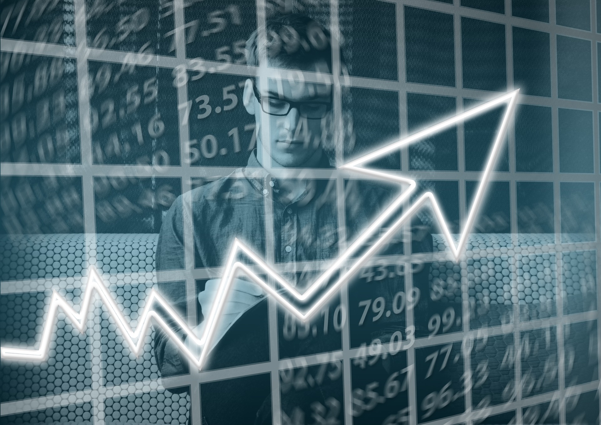 A man writing and a graph pointing upwards.