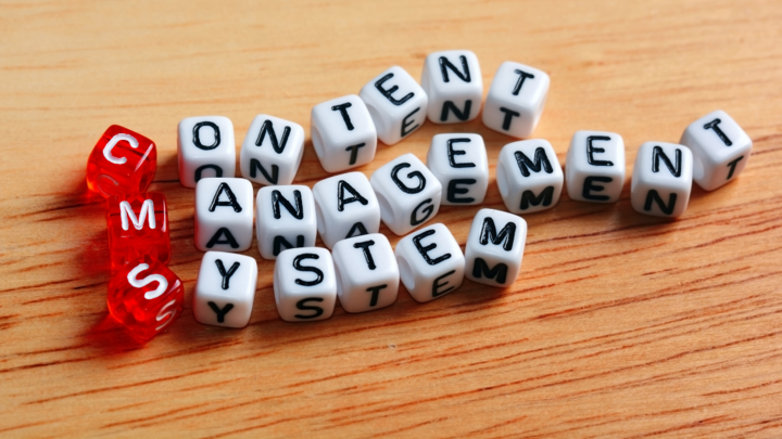 Letter cubes spelling ‘content management system’ on wood background