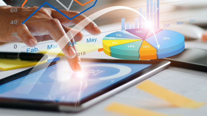 Business professional analyzing marketing performance and analytics dashboard on tablet