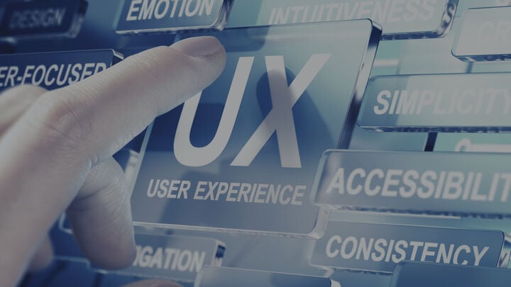 Touch screen that says UX with person touching it