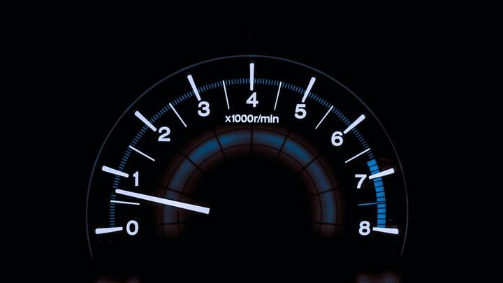 Illustration of a car speedometer pointing to high speed