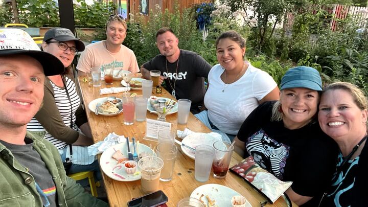 O8 team members sharing a meal outdoors, reflecting the company’s friendly and welcoming team culture.