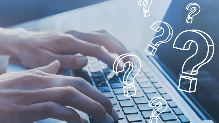 Hands typing on a laptop with question marks representing ChatGPT prompt and context questions.