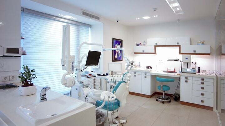 modern dental office with chair and equipment — Photo by Benyamin Bohlouli on Unsplash
