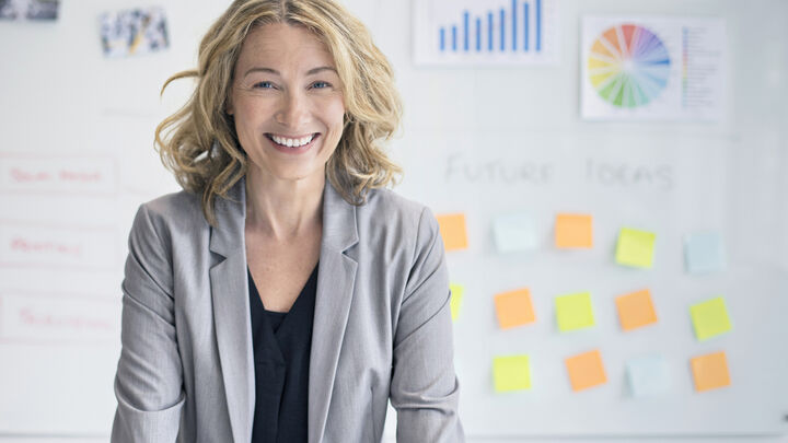 Confident businesswoman against whiteboard 808093602 2124x1416