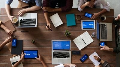 Team meets around the table to collaborate