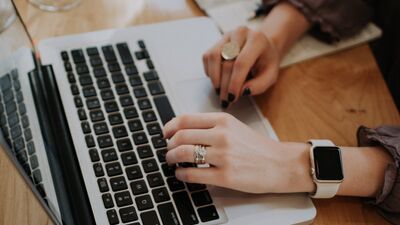 hands typing on laptop keyboard