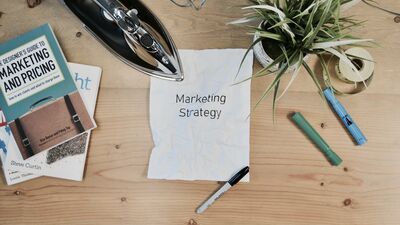 The word "marketing strategy" written on a piece of paper.