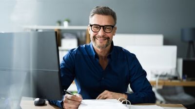 Smiling Man on His Desk