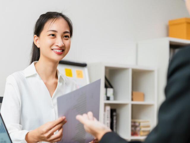Woman Smiling at Her Cowoker