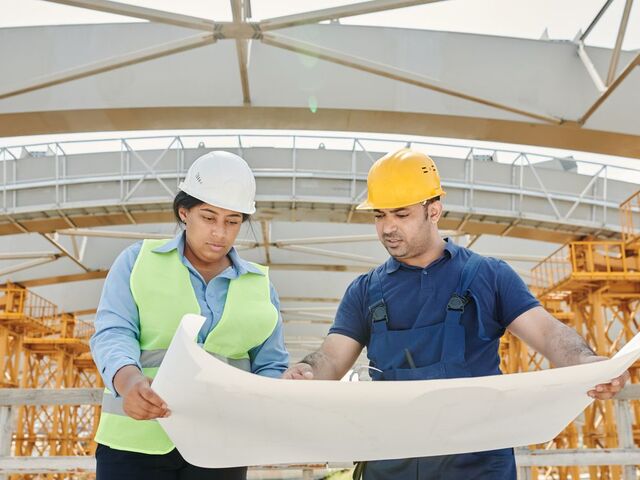 AEC engineering team reviewing blueprints for marketing strategy