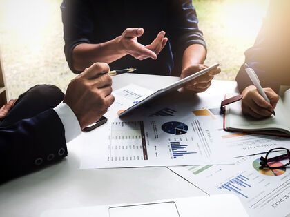 team sitting around a table looking at graphs