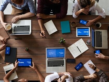 Team meets around the table to collaborate