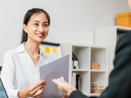 Woman Smiling at Her Cowoker