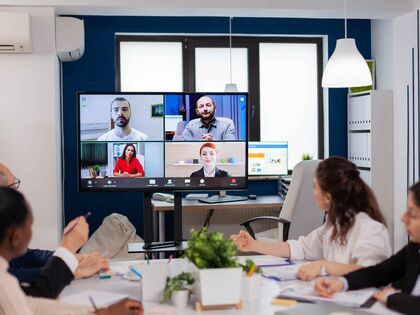 Distributed teams having a video meeting and sharing ideas