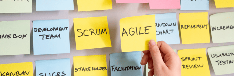 A bunch of post-it notes with the word "Agile" and other terms. 