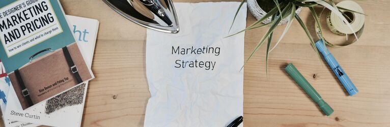 The word "marketing strategy" written on a piece of paper.