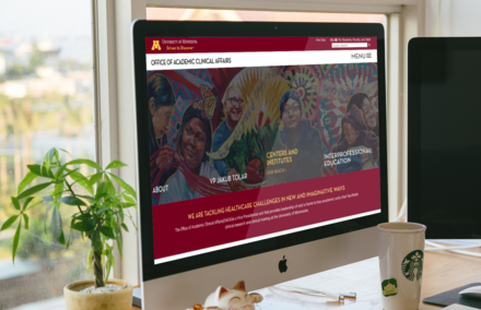 UMN Academic Clinical Affairs website shown on a desktop monitor