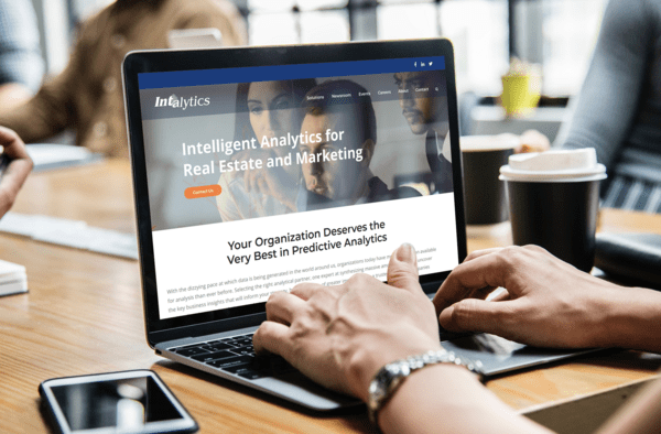 Intalytics website shown on a laptop