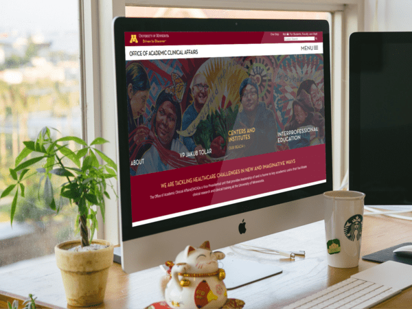 UMN Academic Clinical Affairs website shown on a desktop monitor
