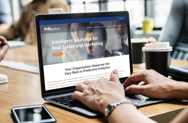 Intalytics website shown on a laptop
