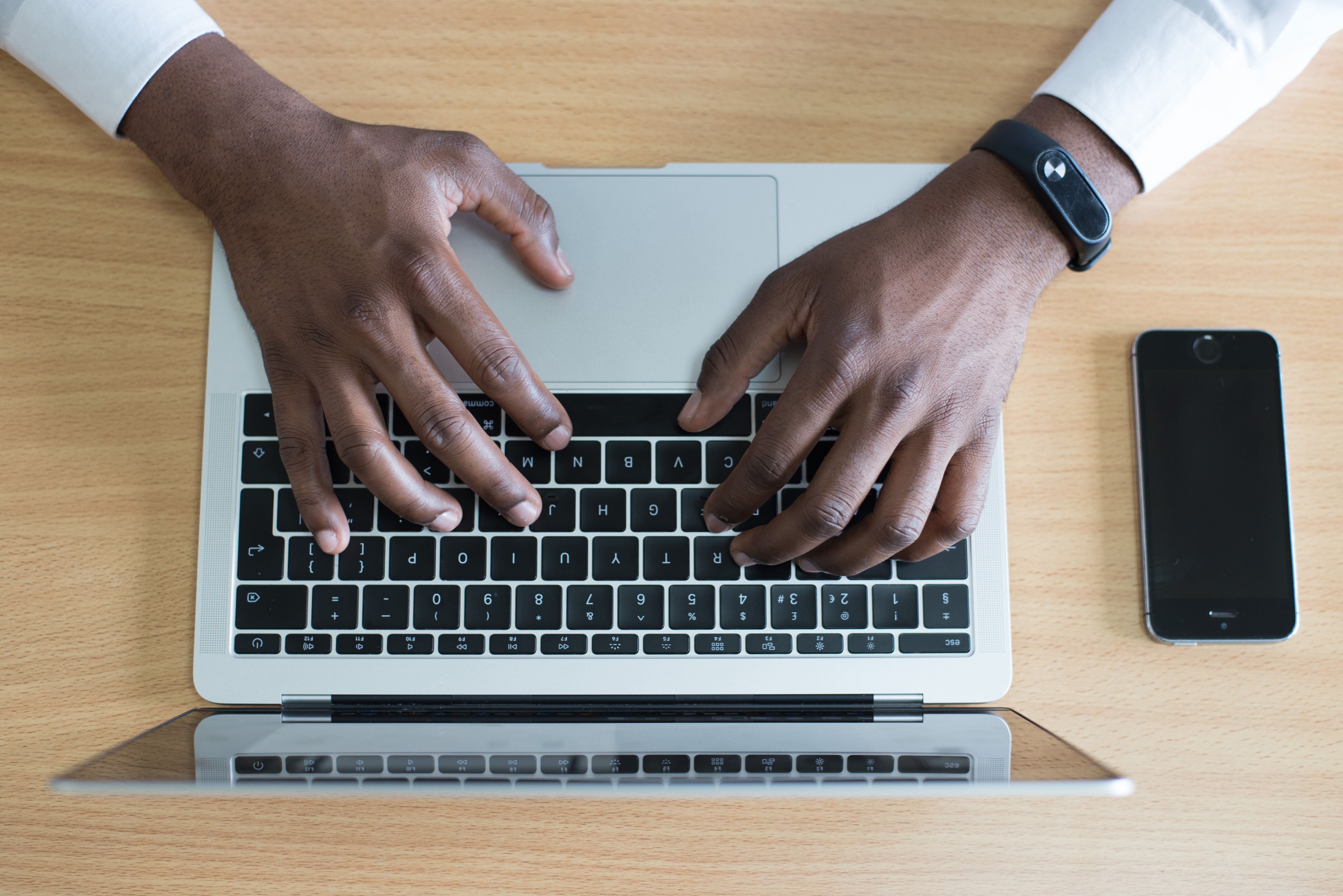 Person typing on a laptop keyboard