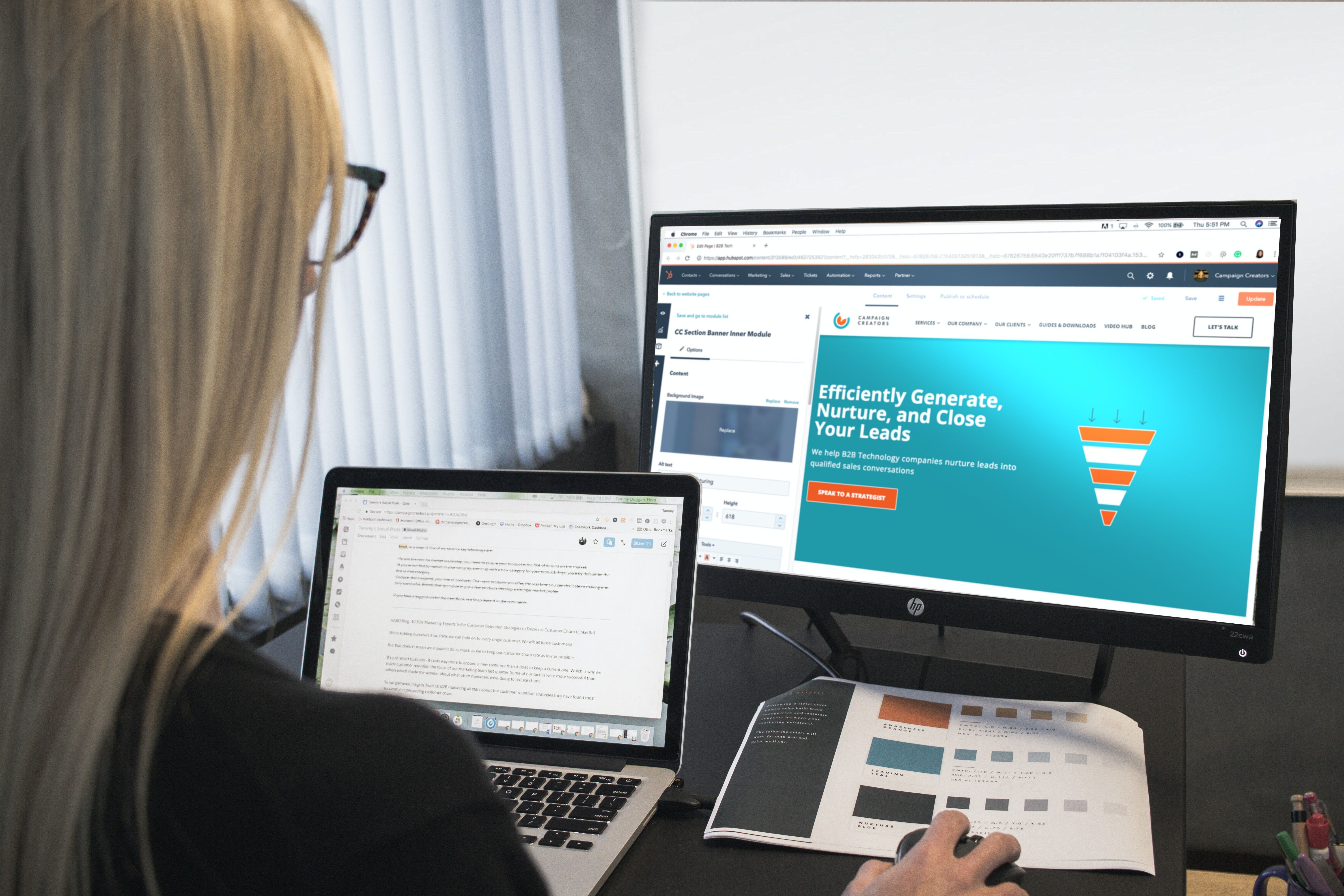 Woman sitting in front of a computer with Hubspot.com displayed on the screen