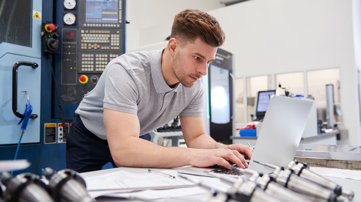 Guy Typing on Laptop Around Equipment