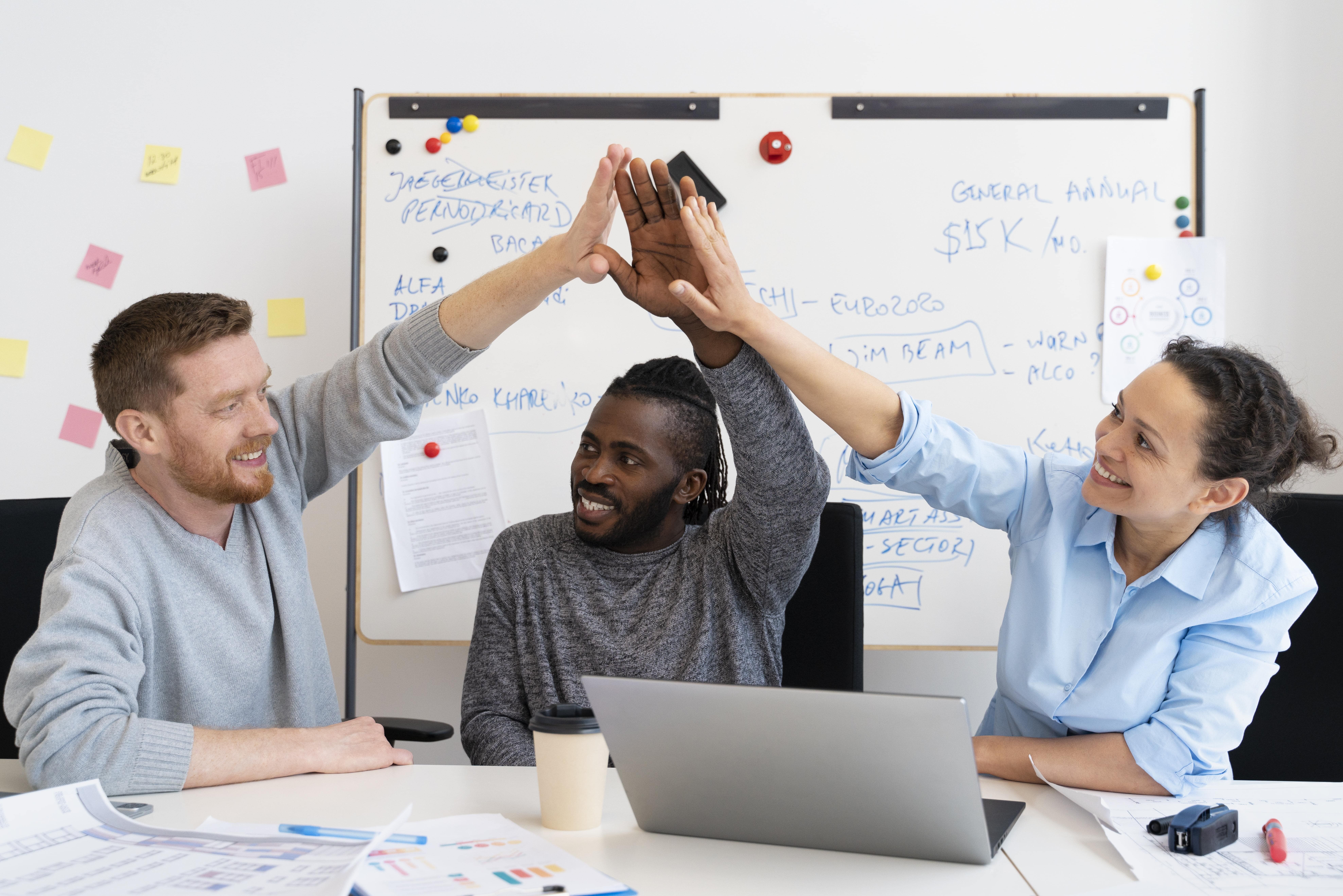Software development team celebrating project success from managing technical debt