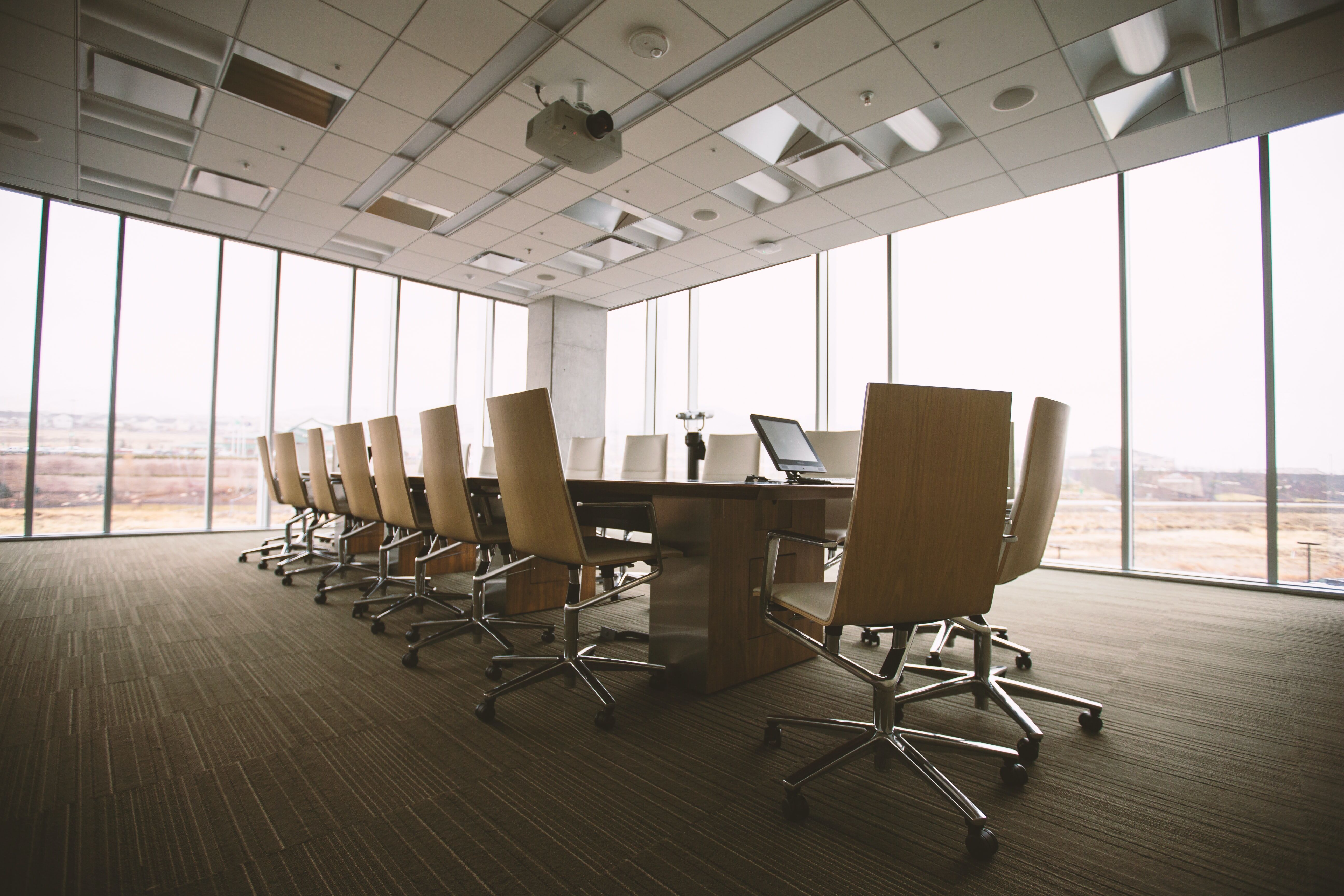 Empty conference room with empty table and chairs