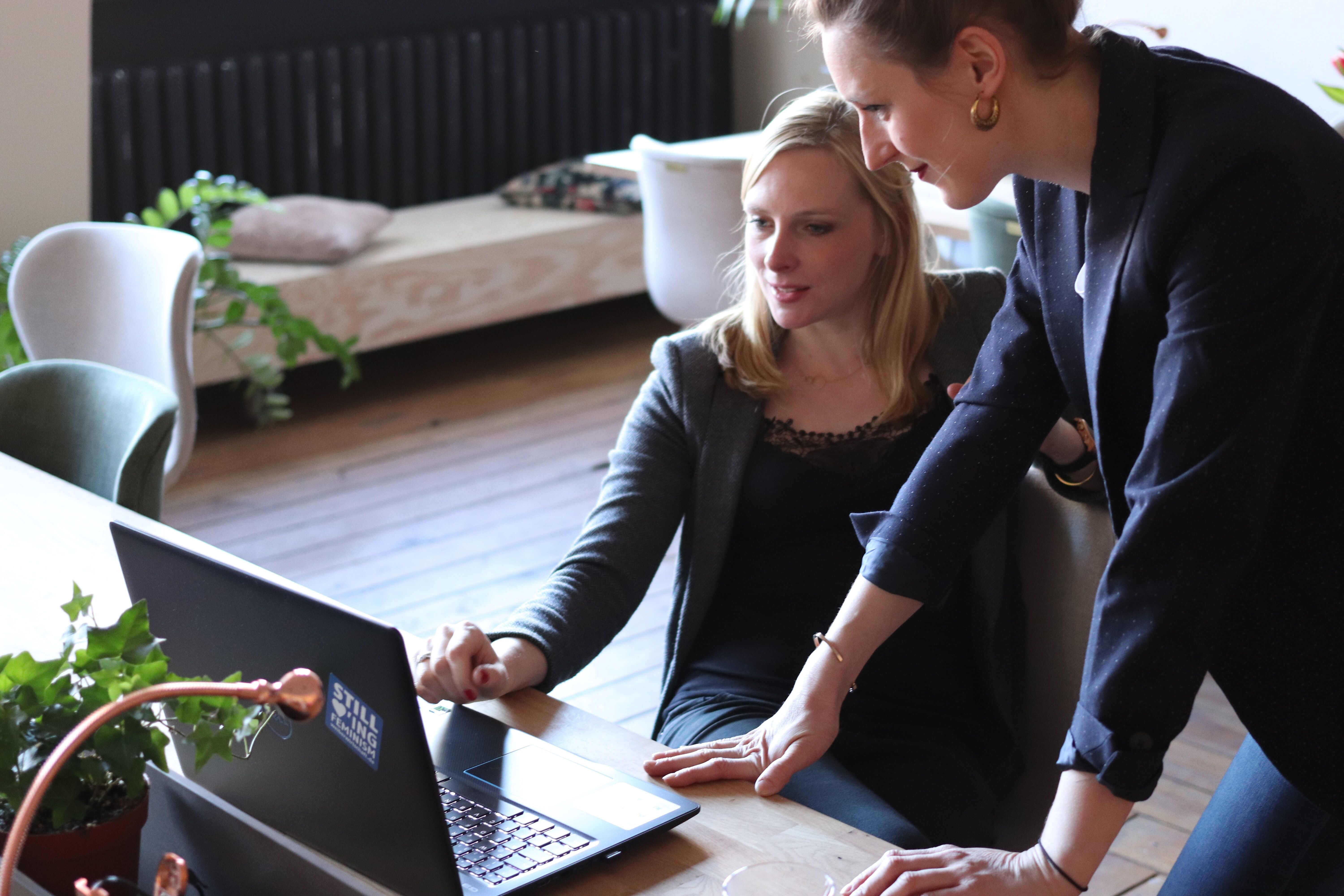 two women looking at a laptop