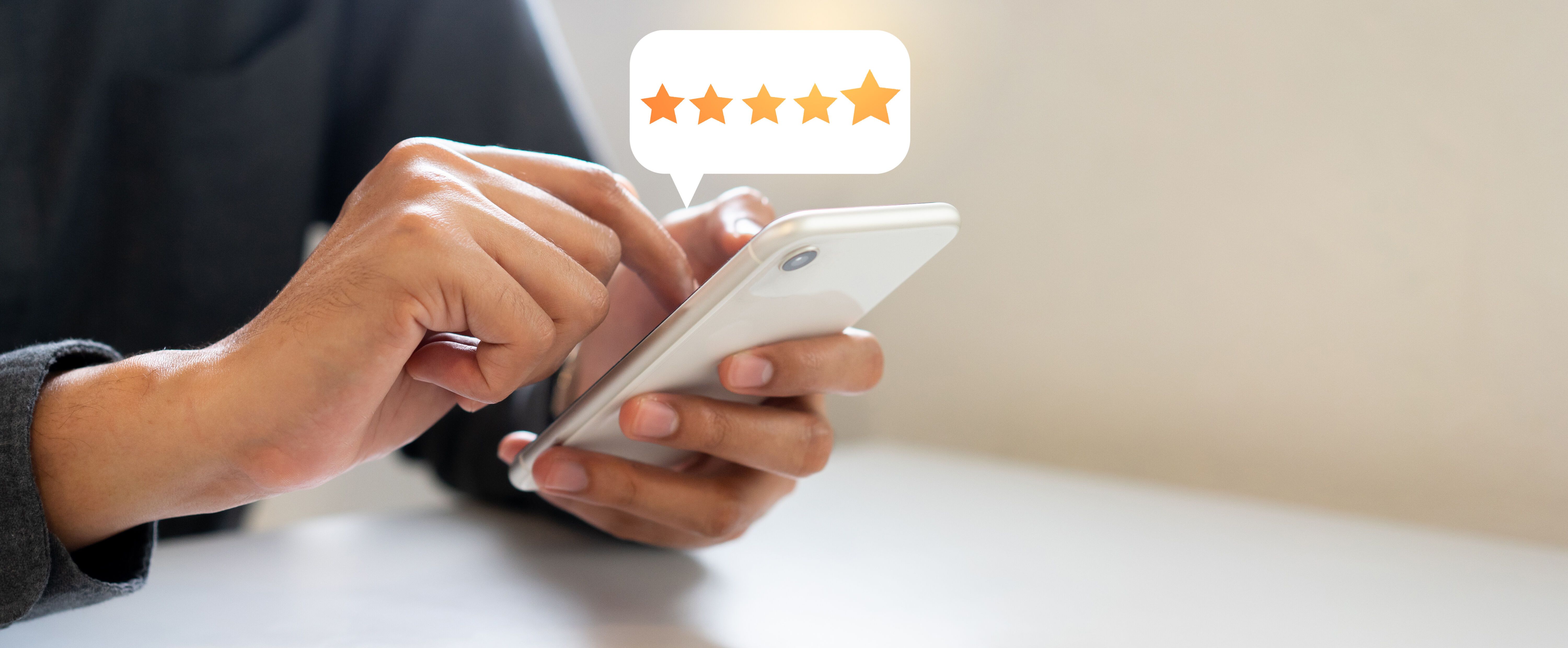 close up on customer man hand pressing on smartphone screen with five star rating feedback icon
